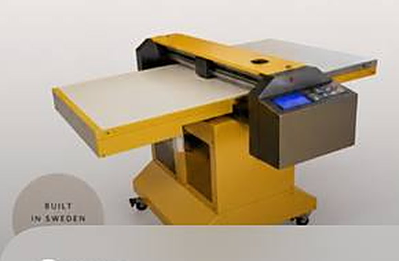 The PoC M-600+ flatbed food printer in yellow, with its printing table extended